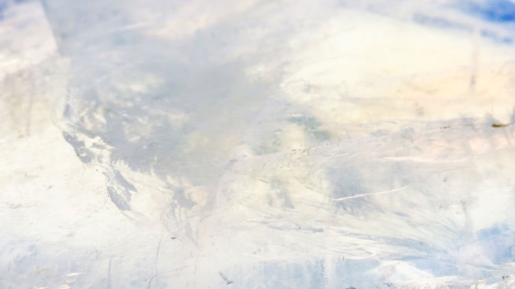 Close-up of a moonstone's pearly luster, reflecting light with hints of blue and white.