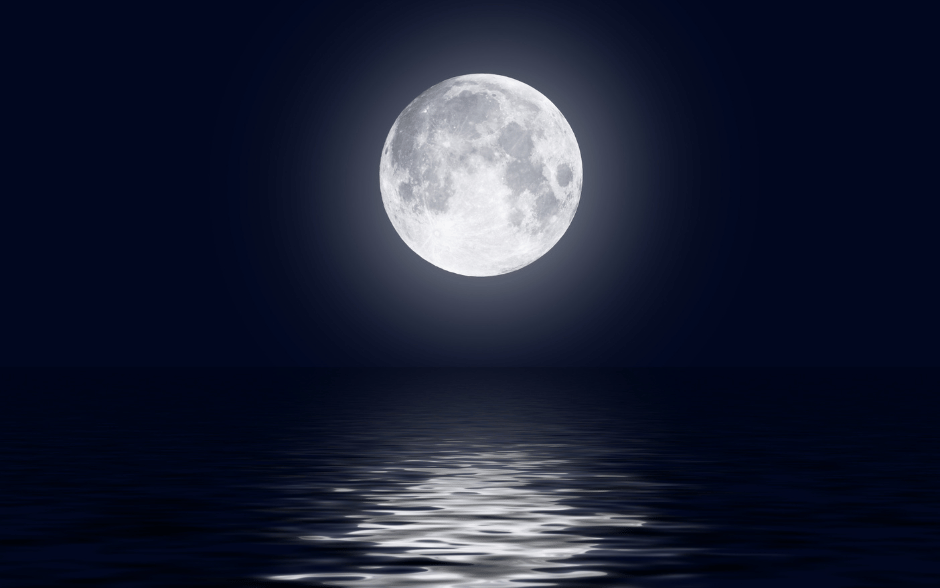 The Sturgeon Moon reflecting on tranquil waters on a clear August night.